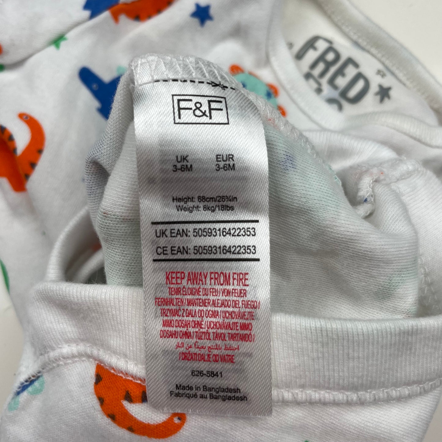 Mehrfarbiger Body mit Dinosauriermuster für Babys, UK Größe 3-6 Monate, aus Baumwolle. – label