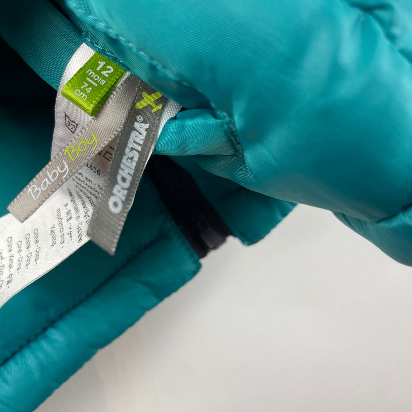 Schwarze und türkisfarbene Wende-Weste für Kleinkinder mit Aufdruck – label