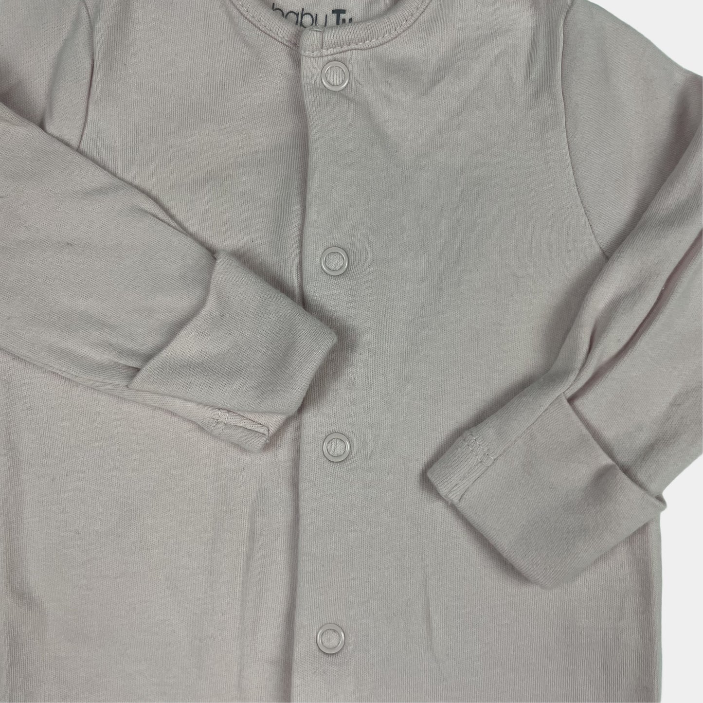 Rosa Strampler mit Füßen und Druckknöpfen aus Bio-Baumwolle – detail