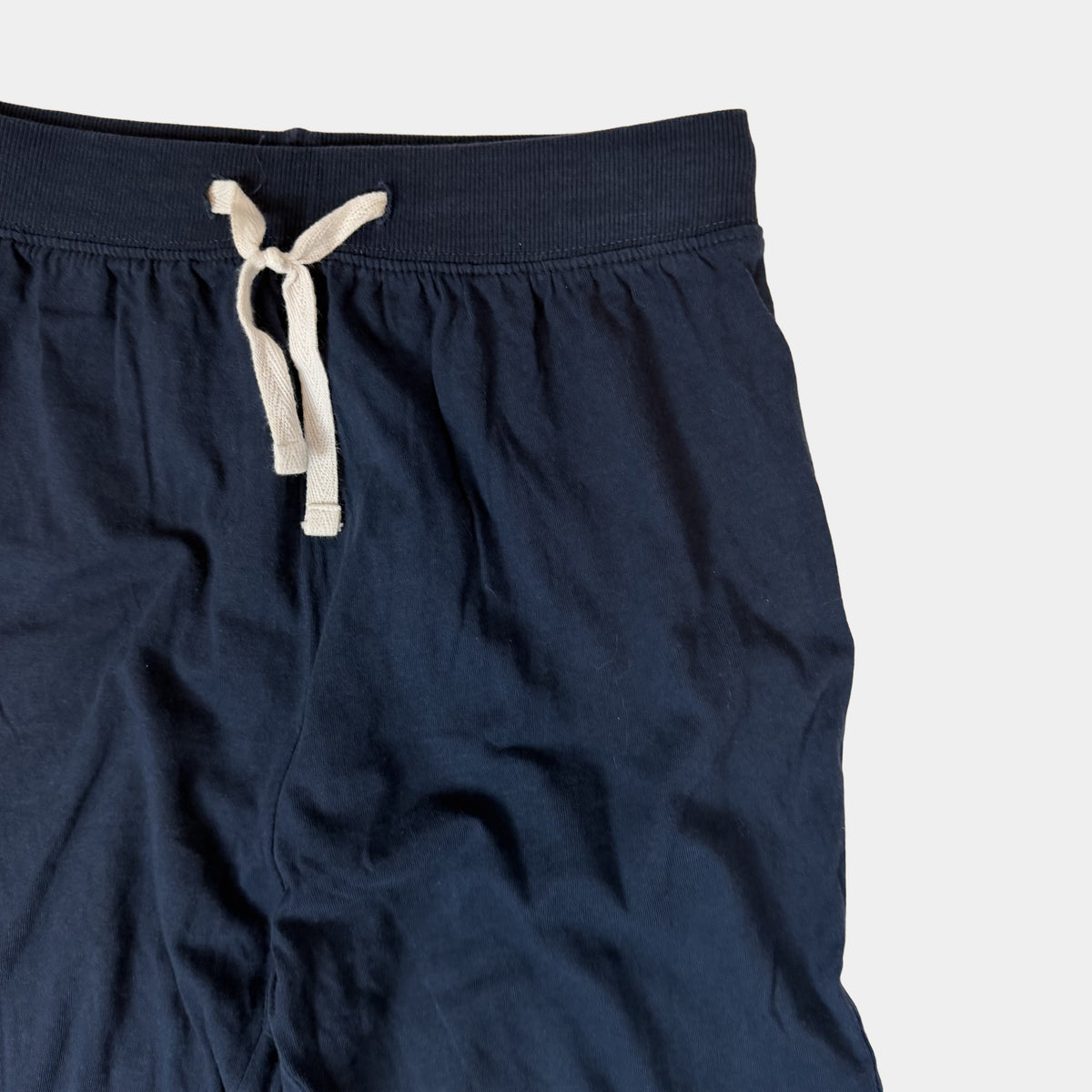 Dunkelblaue Kinder-Jogginghose mit Bindeband und rot-weißem Streifen am Bein – detail